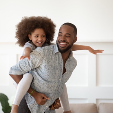 Man carrying a child on his back